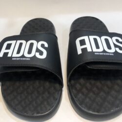 A pair of black slides with the word ados on them.