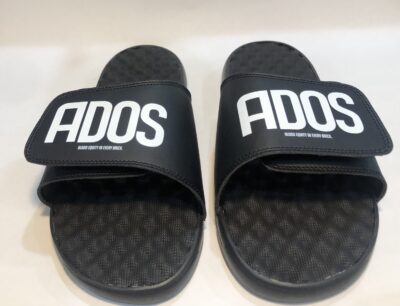 A pair of black slides with the word ados on them.