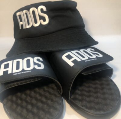 A pair of black slides with the word ados on them.