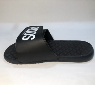 A pair of black sandals with the word " sos " written on them.