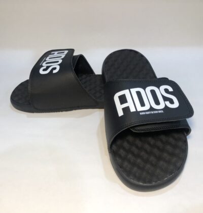 A pair of black slides with the word ados on them.