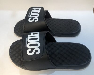 A pair of black sandals with the word " adidas " on them.